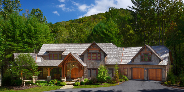 Lodge Home Exterior with beautiful wood work on front door