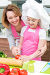 Smiling young mother with daughter cooking., фото № 5959728, снято 16 марта 2014 г. (c) Валуа Виталий / Фотобанк Лори