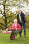 Веселый дедушка катает бабушку в садовой тачке, счастливая пожилая пара, фото № 3091087, снято 17 октября 2009 г. (c) Monkey Business Images / Фотобанк Лори