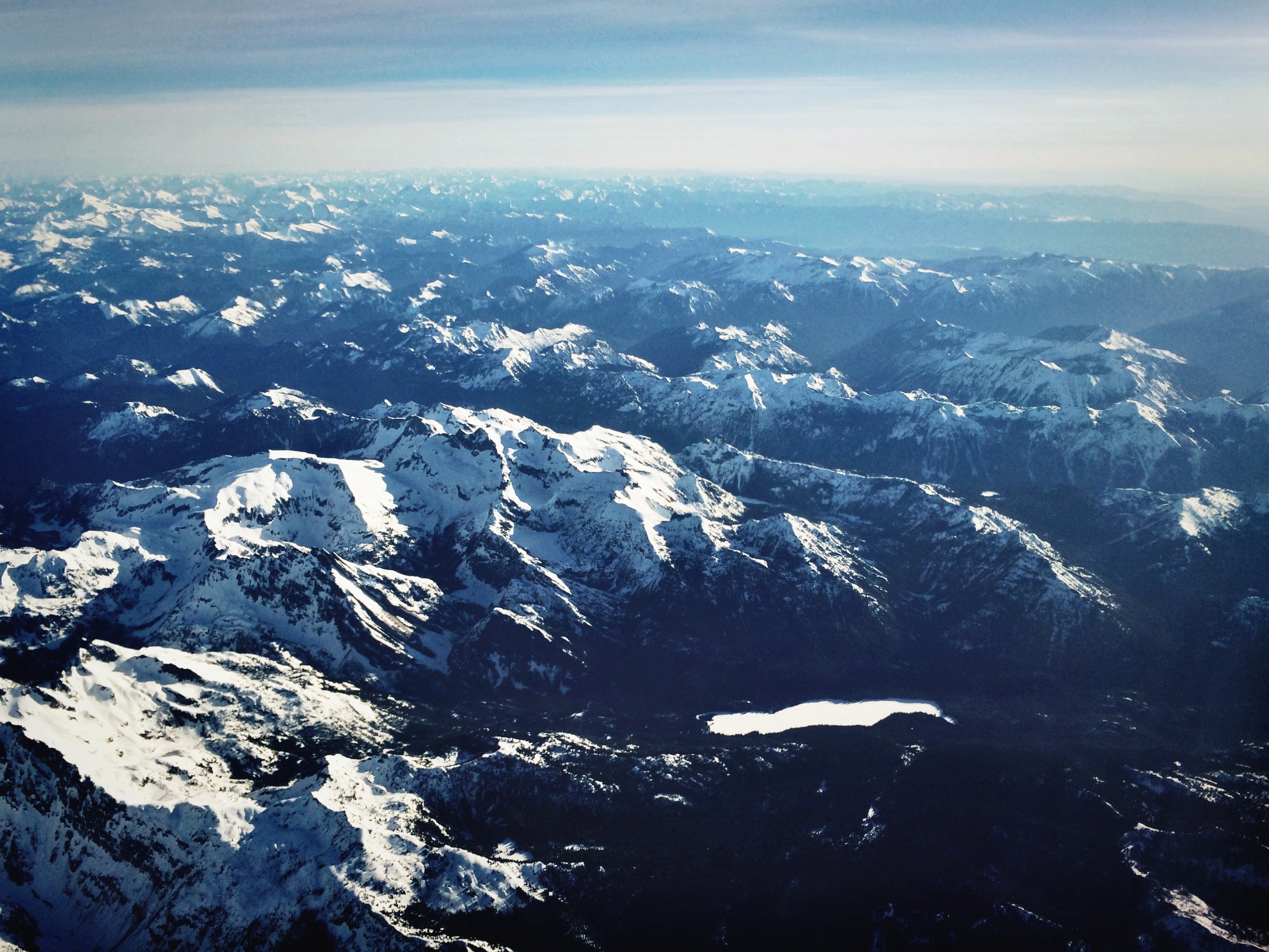 At thirty-seven thousand feet above the Rocky Mountains, the world seems much smaller.