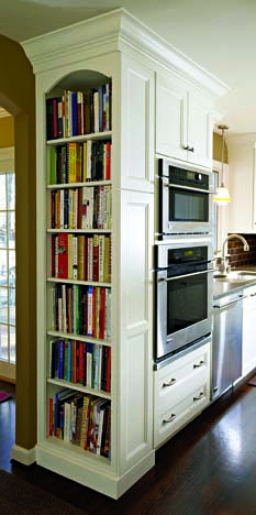 i love the idea of taking an empty wall off the kitchen and turning it into a built-in bookcase for cookbooks