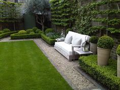 topiary and clipped Buxus (boxwood) low hedges around lawn | perfect contemporary formal garden with seating area | designed by Louise del Balzo Garden Design