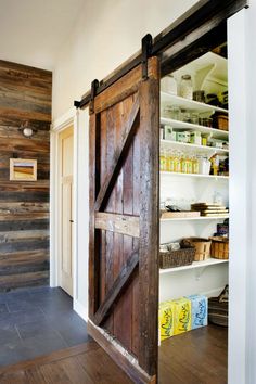 Rustic sliding barn door is a beautiful way to close off the pantry from the kitchen