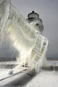 Standing in temperatures well below freezing, this Michigan lighthouse has been transformed into a giant icicle. See others at The Daily Mail (Photo: Thomas Zakowski)