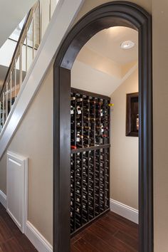 Wine cellar under stairs. Certainly it's normal to want to stash wine in every underutilized space in one's home, right?