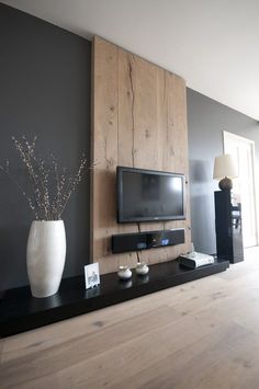 Great idea...paneling on the wall and mounting the tv to the paneling. Hides the cords and looks crisp and clean!