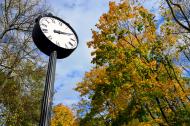 Autumn in the city park with clock.