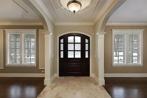 English Entry with light tan stone tile accent flooring