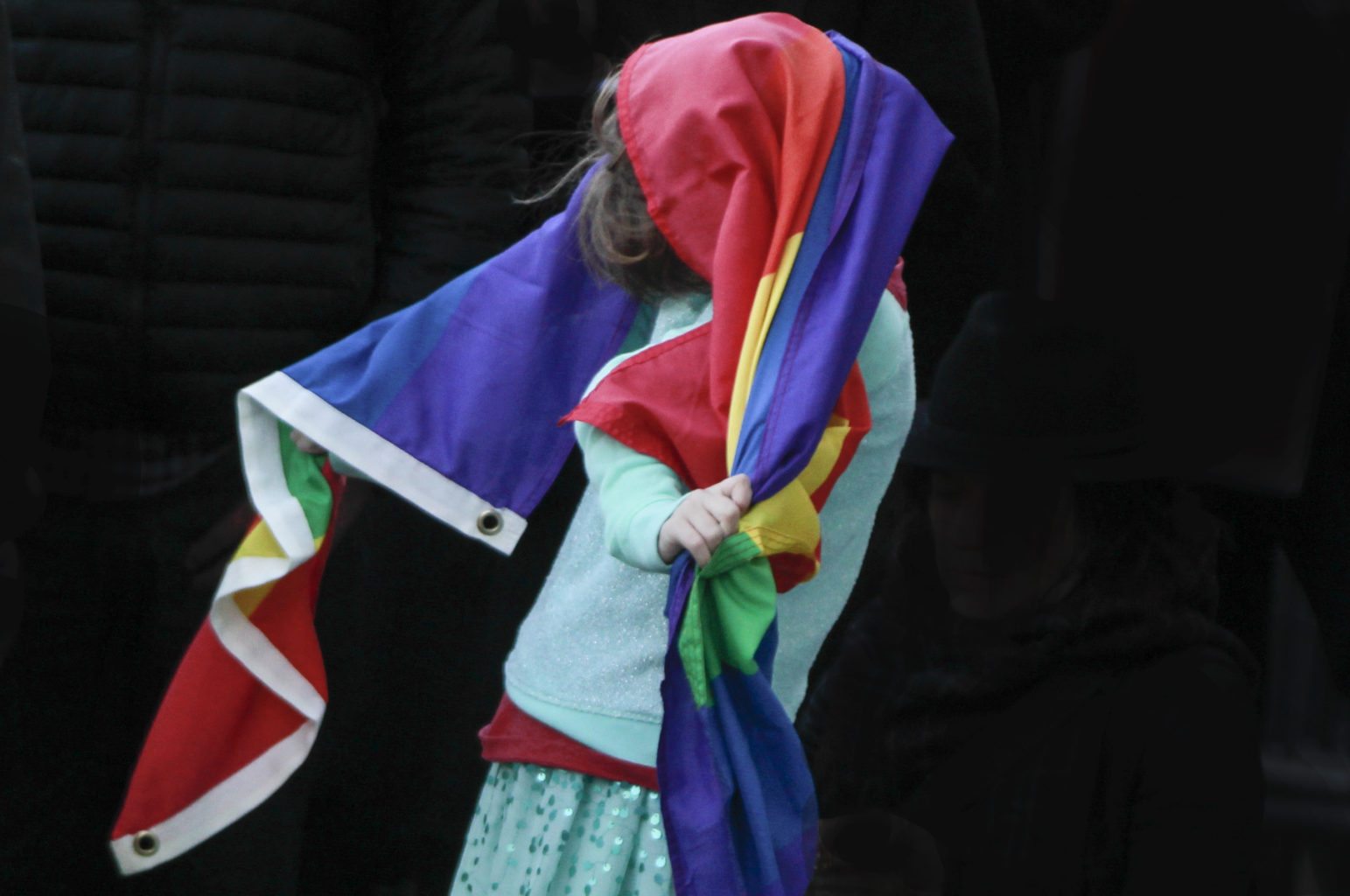 A child plays with a flag during a rally held in solidarity with transgender youth held outside City Hall in San Francisco, Calif. Thursday, February 23, 2017. (Jessica Christian/S.F. Examiner)