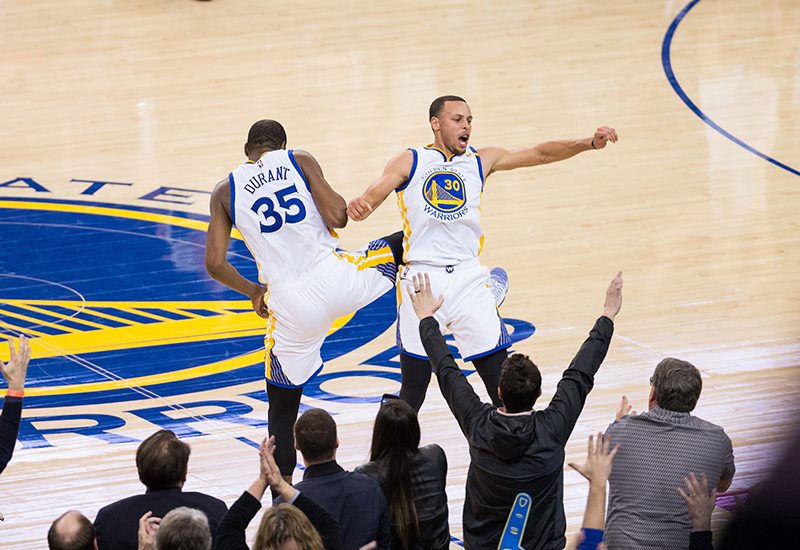 Golden State Warriors guard Stephen Curry (30) and forward Kevin Durant (35) celebrate after hitting a three pointer against the LA Clippers at Oracle Arena in Oakland, Calif., on February 23, 2017. (Stan Olszewski/Special to S.F. Examiner)