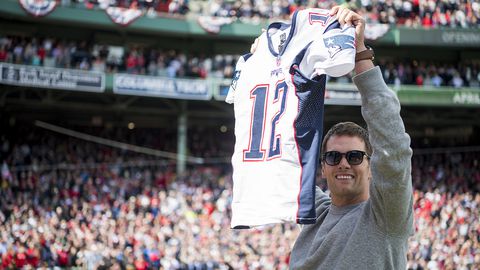 BOSTON, MA - APRIL 03:  Tom Brady #12 of the New England Patriots holds up his recovered jersey during a ceremony honoring the Super Bowl champions at Fenway Park before an opening gay game between the Boston Red Sox and the Pittsburgh Pirates on April 3, 2017 in Boston, Massachusetts. (Photo by Michael Ivins/Boston Red Sox/Getty Images)