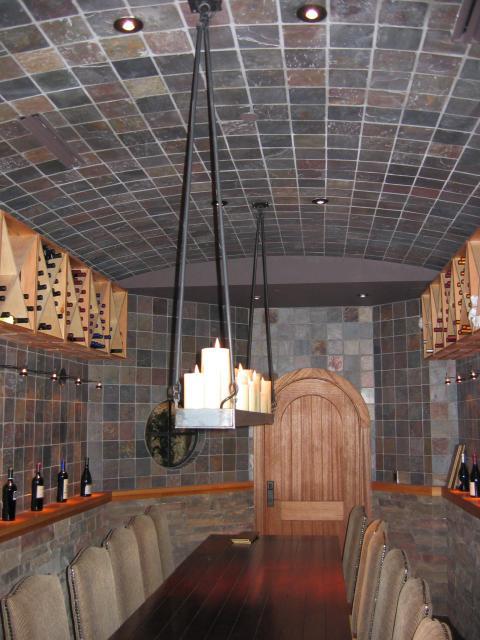Traditional Wine Cellar with stained wood round door