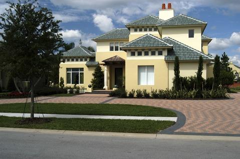 Traditional Driveway with gold painted home exterior