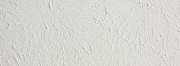 a background of sponge painted, knockdown textured white ceiling in a home