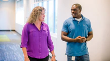 Two team members talking in the office hall