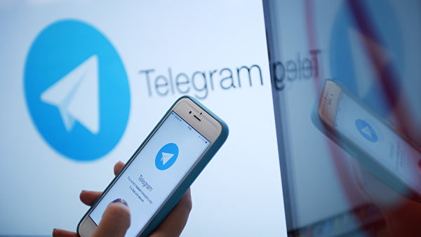 Логотип мессенджера Telegram на экране монитора и телефона