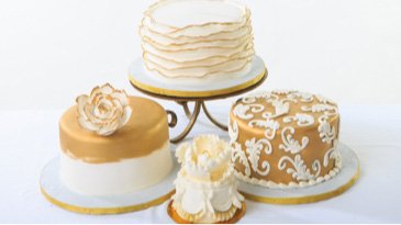 Gambino's bakery gold and white wedding cakes with floral designs 