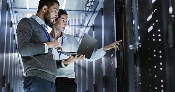 Two people working on enterprise servers