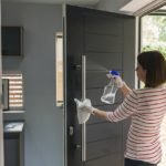 Woman cleaning front door