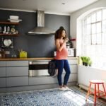 Pregnant woman in tidy modern kitchen in a renovated old building