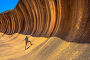 Купить «A sporty man enjoying surfing on the Wave Rock, a natural rock formation that is shaped like a tall breaking ocean wave, in Hyden, Western Australia. Happy funny male in Australian outback.», фото № 32785827, снято 8 мая 2020 г. (c) easy Fotostock / Фотобанк Лори