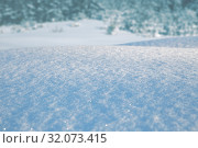 Купить «Natural winter background. Snowdrift of snow sparkling in the sun against backdrop of winter forest», фото № 32073415, снято 6 марта 2019 г. (c) Юлия Бабкина / Фотобанк Лори