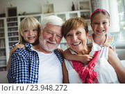 Купить «Portrait of grandparents smiling with their grandchildren», фото № 23948272, снято 1 июля 2016 г. (c) Wavebreak Media / Фотобанк Лори