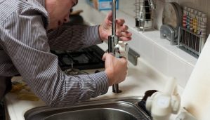 Plumber working on a faucet