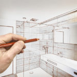 man draws plan for his bathroom remodel