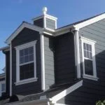 Suburban house with grey siding and white trim