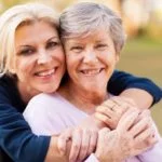 daughter embracing mother with alzheimers