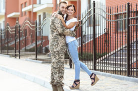 Happy US army soldier with wife on street