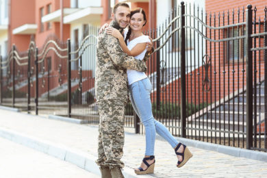 Happy US army soldier with wife on street