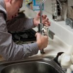 Plumber working on a faucet