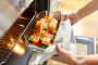 woman cooking food in oven at home kitchen. Стоковое фото, фотограф Syda Productions / Фотобанк Лори