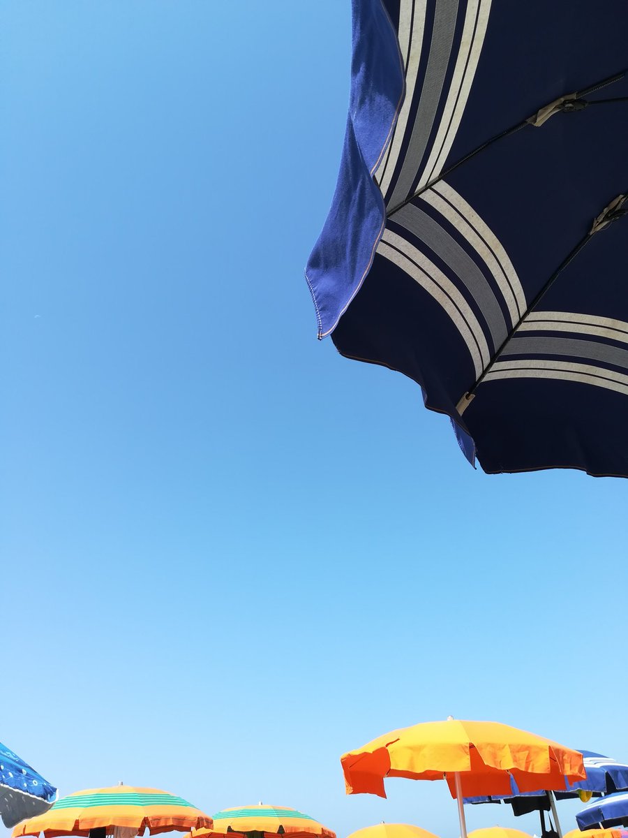 Beach umbrellas and blue clear sky