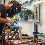 Man welding in his shop