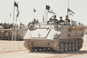 Chief of Staff David Elazar (1925-1976) reviews ranks of Israel Defense Force troops from an armoured personnel carrier as they line up with Patton and Centurion tanks in the Sinai Desert at the end of the country's biggest military exercises since the six-day war, Israel, 22nd March 1972. (Photo by 