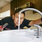 Plumber fixing a kitchen sink