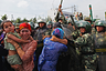 URUMQI, CHINA - JULY 07: Chinese policemen push Uighur women who are protesting at a street on July 7, 2009 in Urumqi, the capital of Xinjiang Uighur autonomous region, China. Hundreds of Uighur people have taken to the streets protesting after their relatives were detained by authorities after Sunday's protest.  Ethnic riots in the capital of the Muslim Xinjiang region on Sunday saw 156 people killed. Police officers, soldiers and firefighters were dispatched to contain the rioting with hundreds of people being detained.  (Photo by Guang Niu/Getty Images)