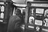 Man throughly engaged in the delights of coin-operated Peep Show machine featuring films of Beautiful Girls and Exotic Dancers in ALL DANCE SHOW (3 subjects-10 cents each) in Arcade on 42 St. in the tawdry Time Square area. 
