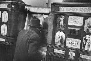 Man throughly engaged in the delights of coin-operated Peep Show machine featuring films of Beautiful Girls and Exotic Dancers in ALL DANCE SHOW (3 subjects-10 cents each) in Arcade on 42 St. in the tawdry Time Square area. 