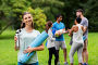 smiling woman with yoga mat and bottle at park. Стоковое фото, фотограф Syda Productions / Фотобанк Лори