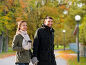 couple with tumbler walking along autumn park. Стоковое фото, фотограф Syda Productions / Фотобанк Лори