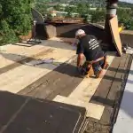 Roofer working on flat roof repair