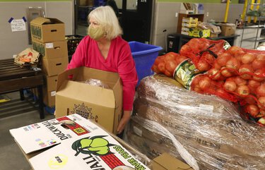 Sue Brangwin volunteers putting together food pickups at Hopelink, Tuesday, Nov. 24, 2020 in Shoreline. 215739