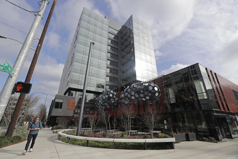 An Amazon employee who works at the company’s Brazil building in Seattle has tested positive for COVID-19, the illness caused by the novel coronavirus. Amazon appears to be letting some employees work from home, with approval from a manager. (Ted S. Warren / The Associated Press)