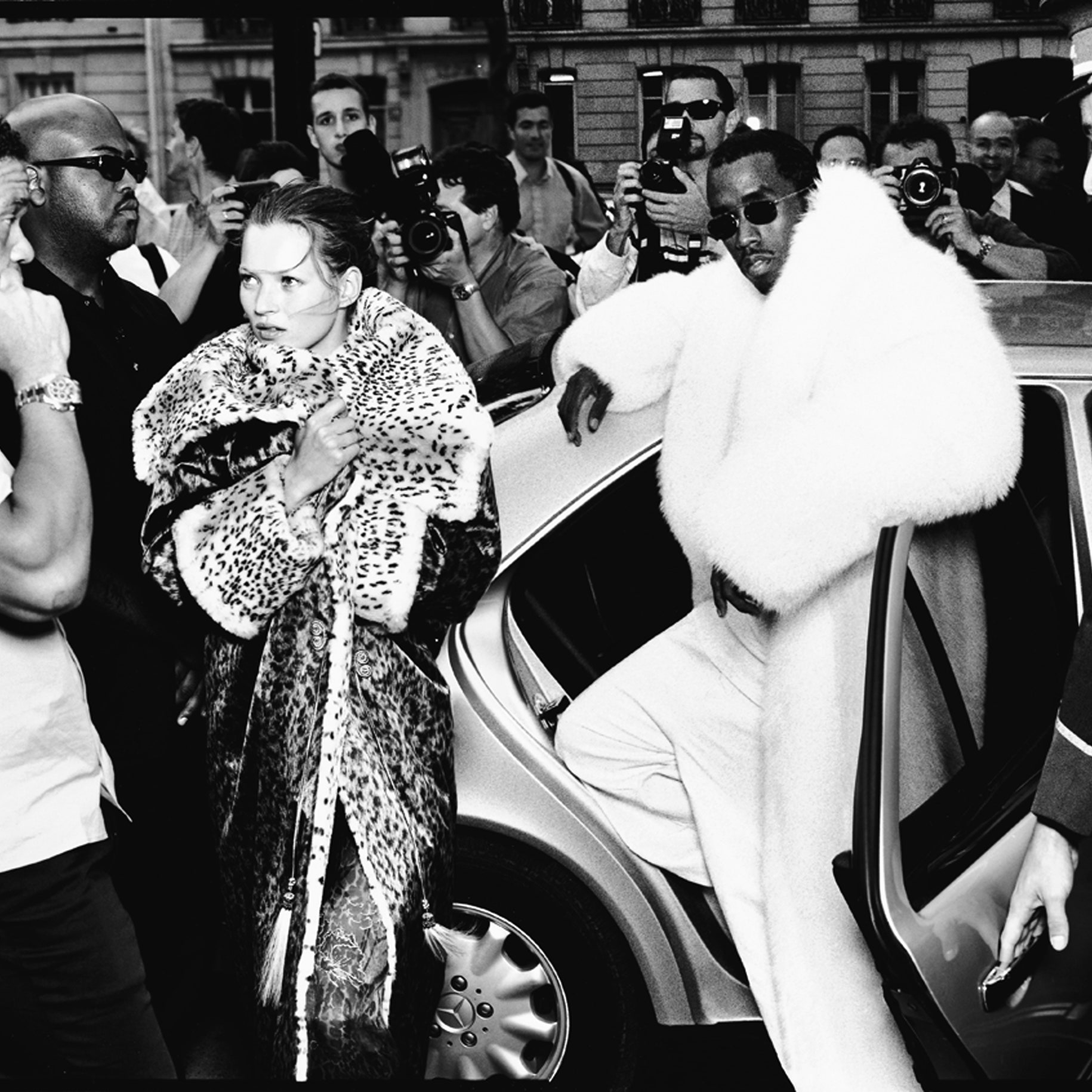 Image may contain Human Person Banky W. Kate Moss Clothing Suit Coat Overcoat Apparel Sunglasses and Accessories