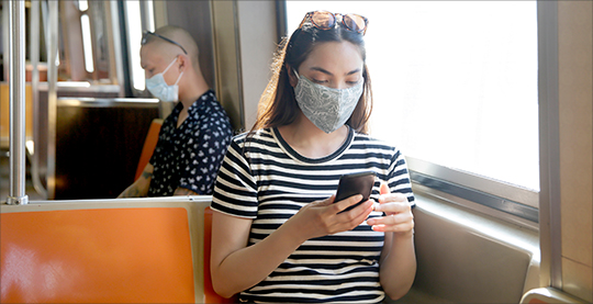 Woman with mask on NYC subway