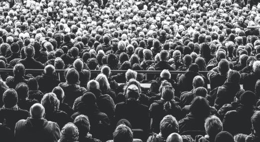 The Image shows an audience in black and white.